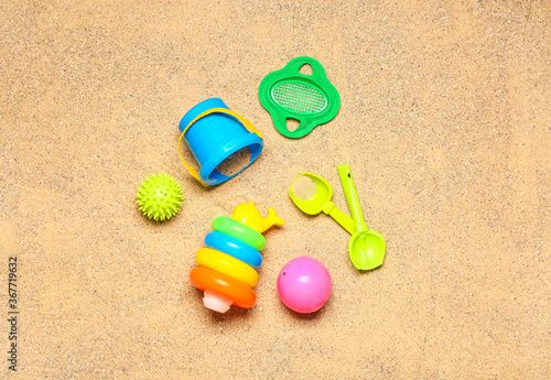 Set of beach accessories for children on sand, top view
