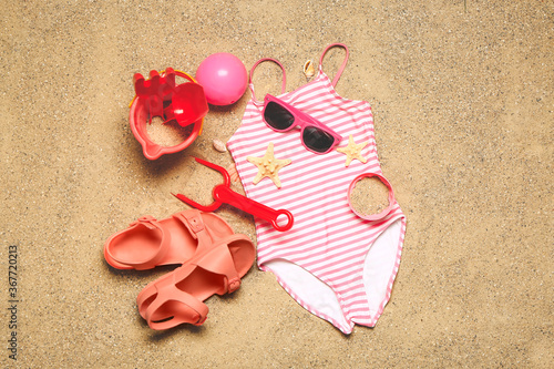 Set of beach accessories for children on sand  top view