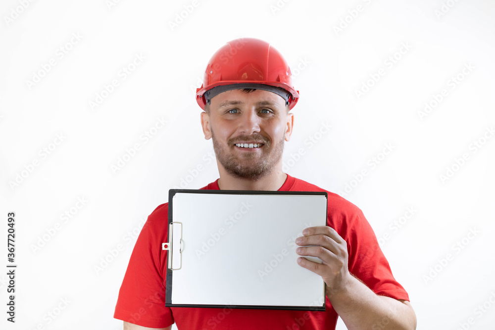 A man in a helmet and a red T-shirt holds an ad in his hands A man in a helmet and a red T-shirt holds an ad in his hands