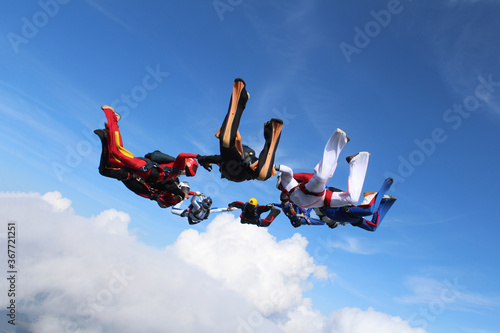 Skydiving. A circle figure of skydivers is in the sky.