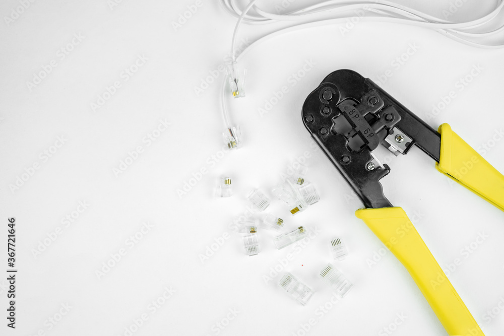 Fotografia do Stock or telephone line cables and crimper, Twisting Cable Tool Twisted