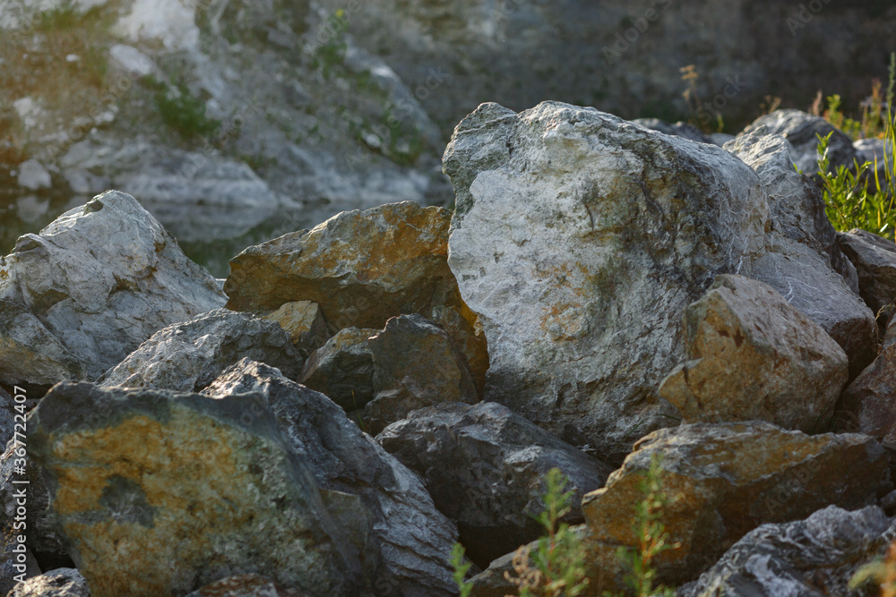 Natural gray gypsum stone. Close up image of stones with black and white. Industrial mining area. Limestone mining, quarry.