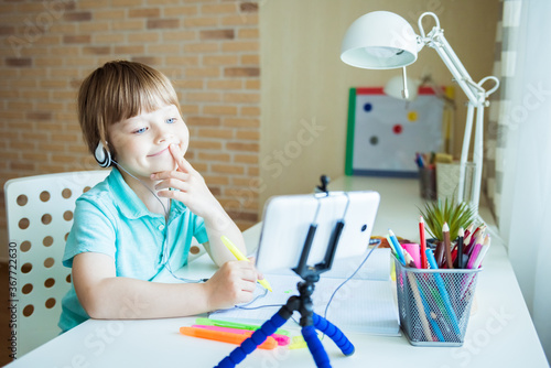 Cute little boy painting with color pencils at home, in kindergaten or preschool. Creative games for kids staying at home photo