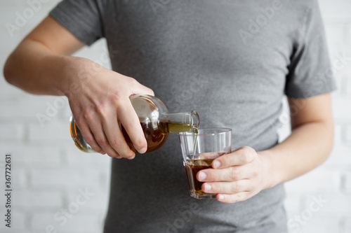 male hands pouring alcohol into glass