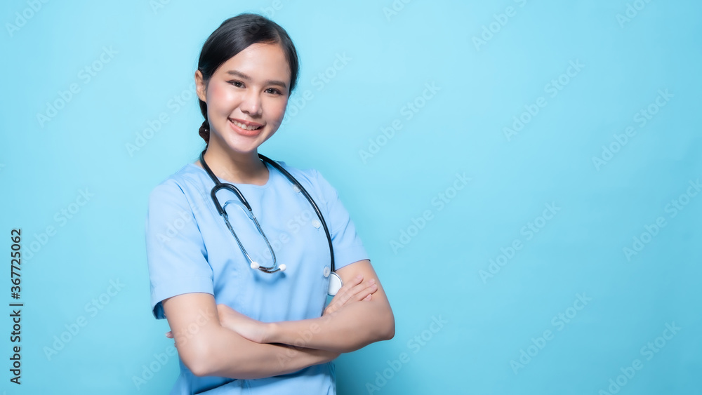 Asian Thai nurse or doctor with stethoscope with big smiled isolated in studio on blue background Asian Thai nurse or doctor with stethoscope with big smiled isolated in studio on blue background