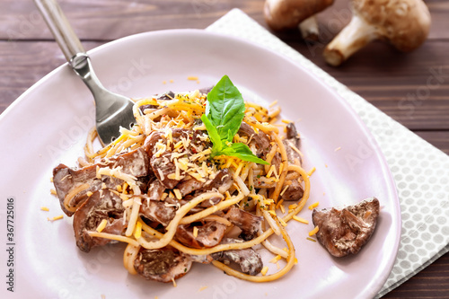 Eating of tasty pasta with mushrooms from plate