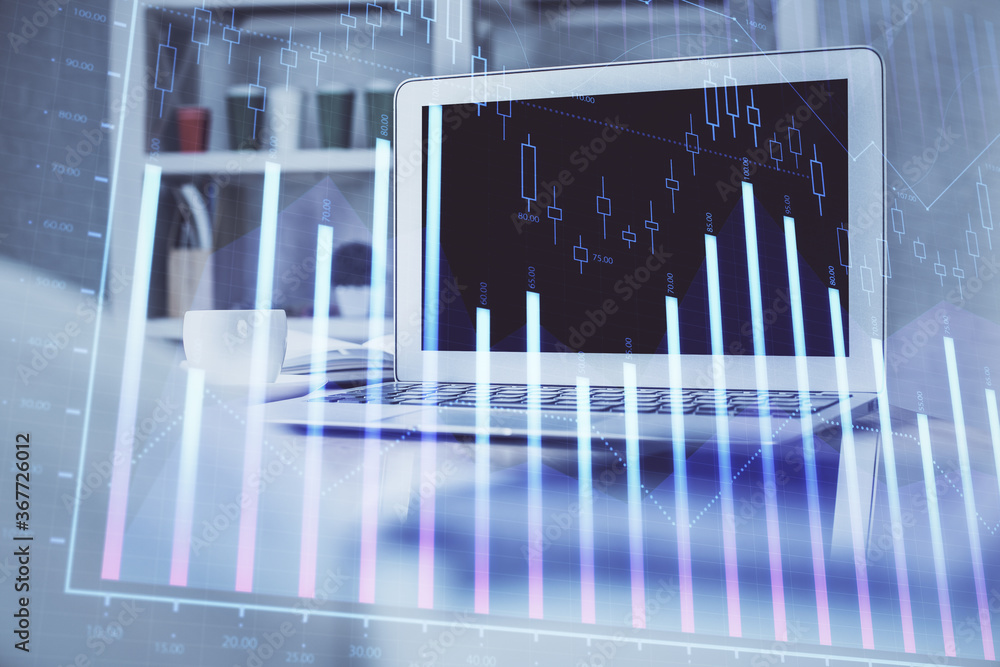 Stock market chart hologram drawn on personal computer background. Multi exposure. Concept of investment. Stock market chart hologram drawn on personal computer background. Multi exposure. Concept of investment.