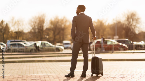 Businessman On Business Trip Standing With Suitcase Outdoors, Panorama, Rear-View