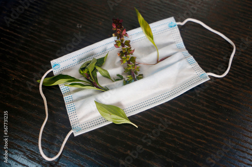 Face medical mask with Basil flower. memories of a dead people due to coronavirus