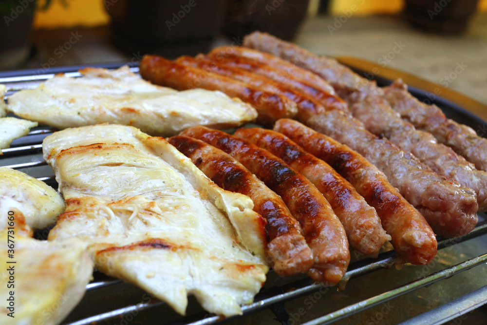 Assorted grilled meat on a barbecue grill.