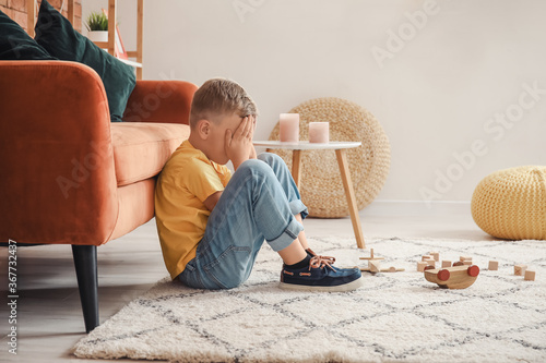 Sad little boy with autisti...