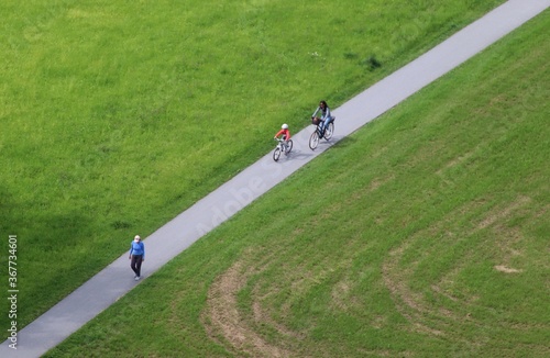 Small walkway from above with walking person and cyclists