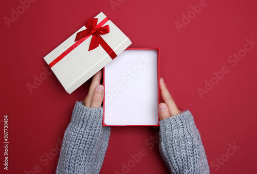 Holiday gift box opened.Hands holding present box top view.Product display. photo