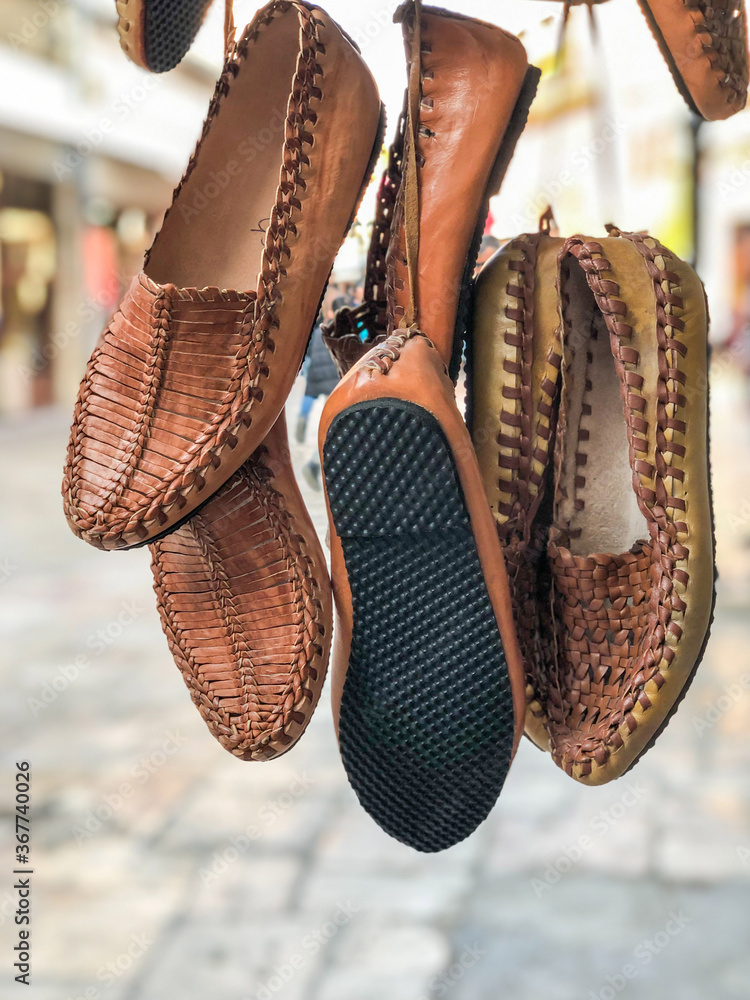 handmade leather shoes hanged in the bazaar Stock Photo | Adobe Stock