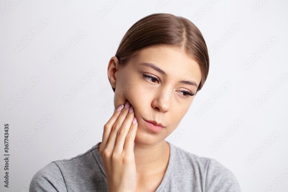 Portrait of a pretty young woman having a severe toothache Portrait of a pretty young woman having a severe toothache