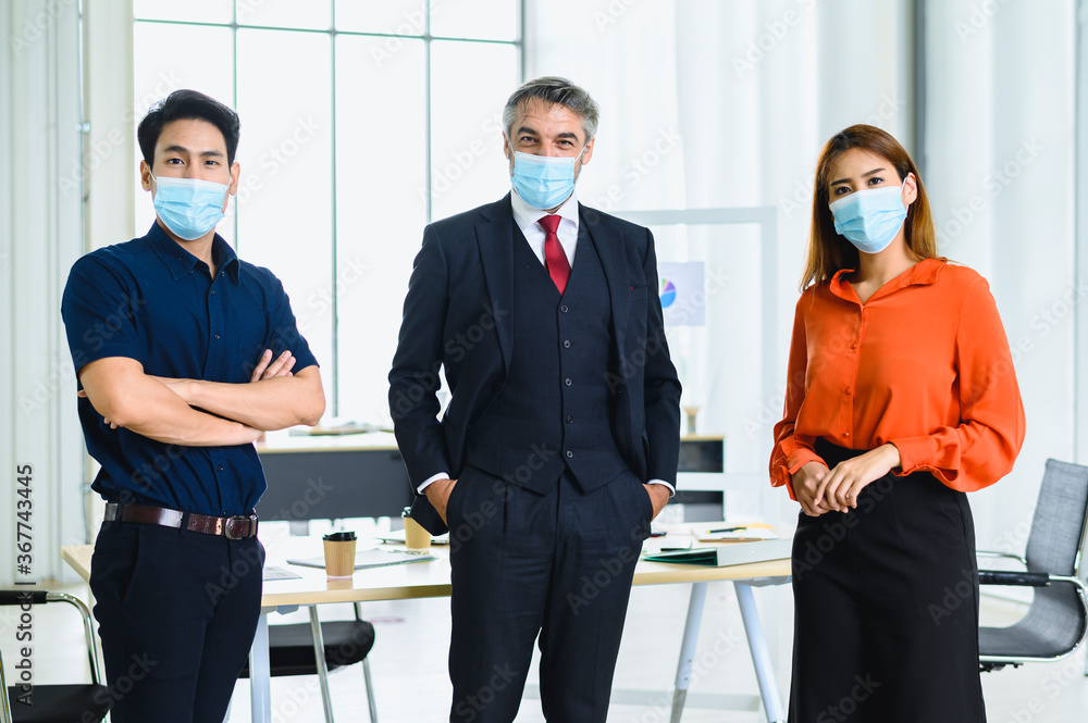 Fototapeta premium Business office people maintain social distancing meeting room. Stop covid-19 coronavirus. New normal lifestyle in job.