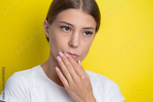 Portrait of a pretty young woman having a severe toothache