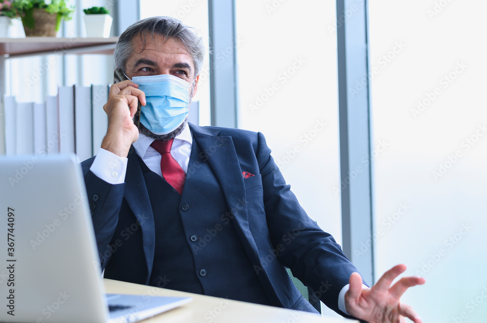 Senior management with face mask back at work in office after lockdown, Senior management with face mask back at work in office after lockdown,
