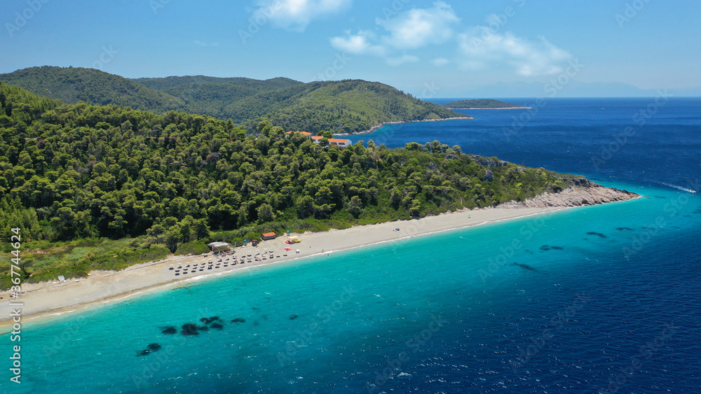 Aerial drone panoramic photo of famous turquoise paradise beach of Milia covered with pine trees, Skopelos island, Sporades, Greece Aerial drone panoramic photo of famous turquoise paradise beach of Milia covered with pine trees, Skopelos island, Sporades, Greece