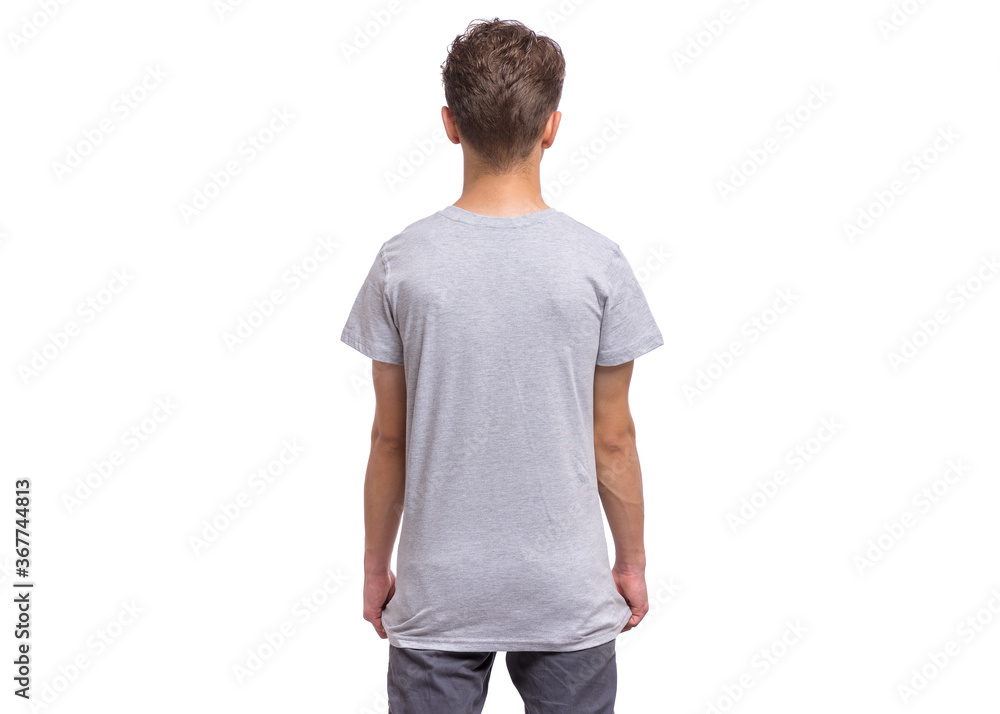 T-shirt design concept. Teen boy in blank gray T-shirt, isolated on white background - back view. Mock up template for print. Child - rear view. T-shirt design concept. Teen boy in blank gray T-shirt, isolated on white background - back view. Mock up template for print. Child - rear view.