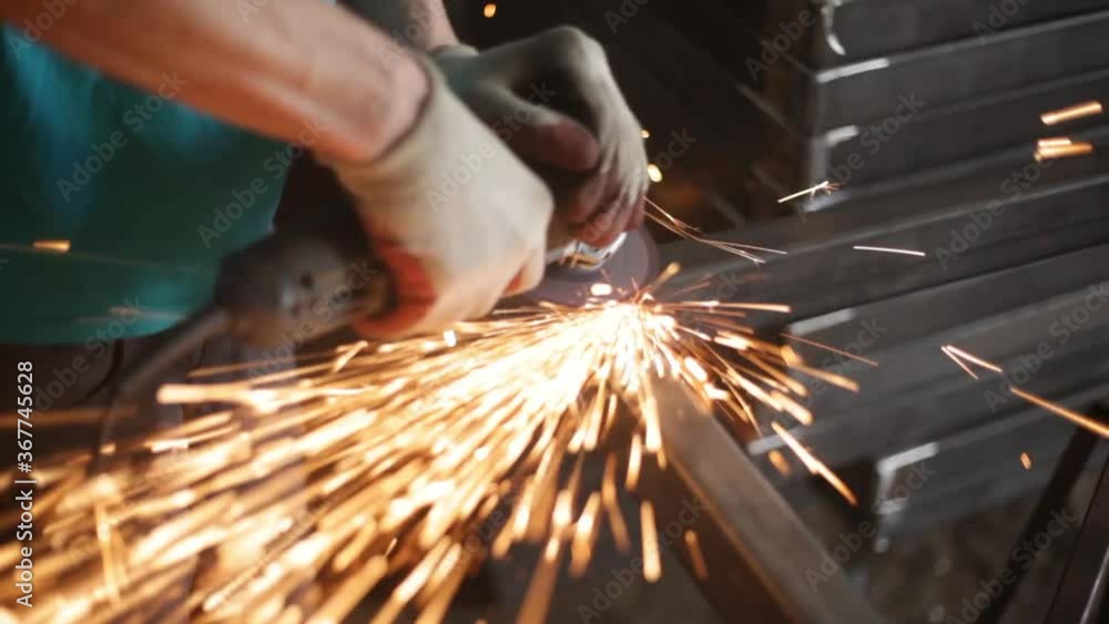 Grinding metal with a grinder. Metal profile corners processing. Work