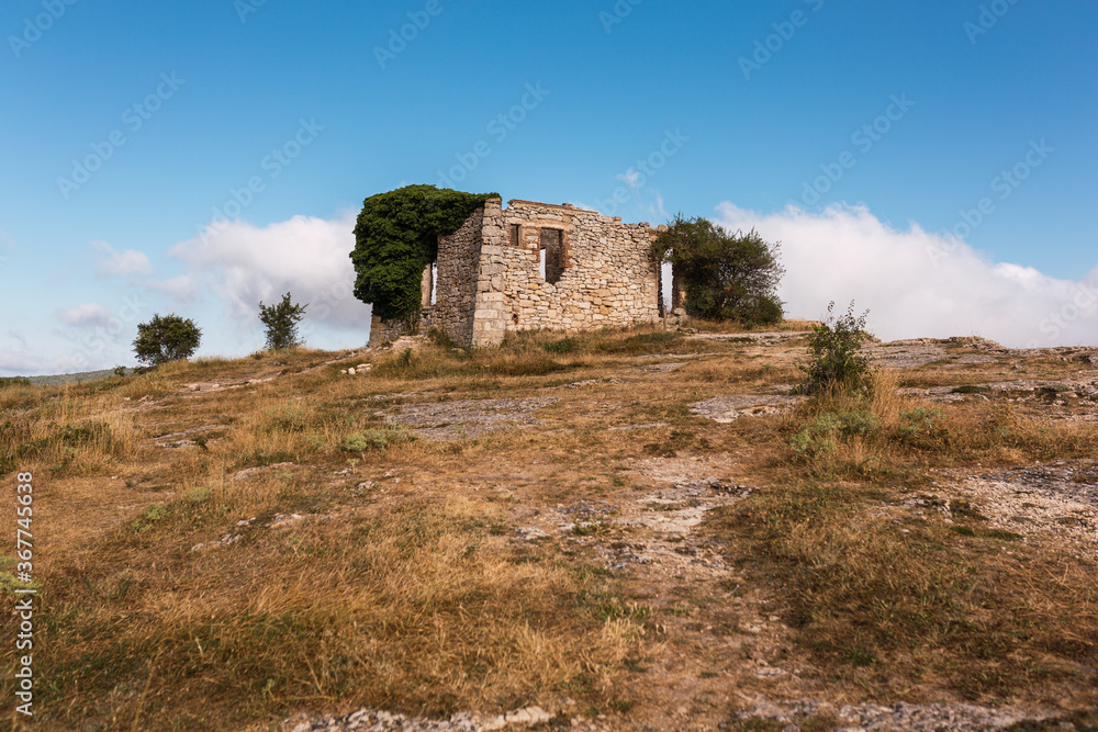 ruins of a house in La Mussara (Tarragona, Spain), above everything on a hill with a cliff