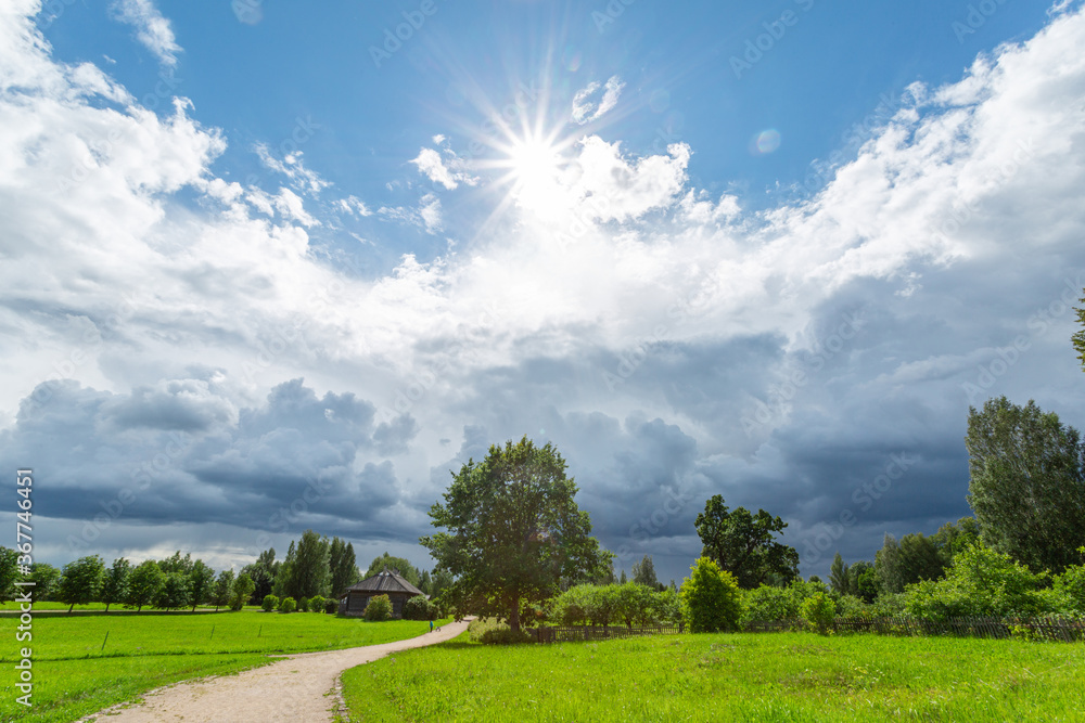 Picturesque summer landscape with green field and the cloudy sky. Horizontal image. Picturesque summer landscape with green field and the cloudy sky. Horizontal image.