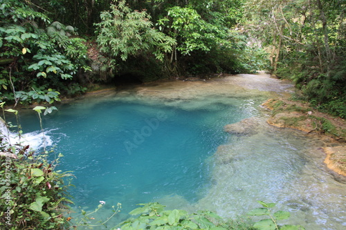 Beautiful turquoise blue green water with green vegetation jungle in the mountain volcano lack and river in Cuba.
