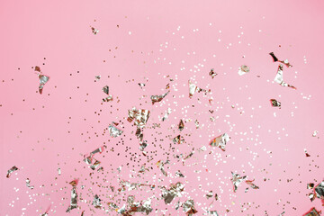 Golden stars glitter on pink background. Festive holiday pastel backdrop.