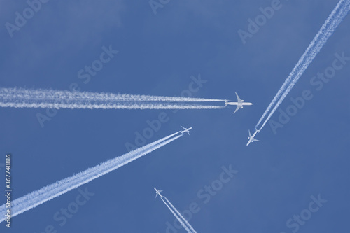 Passenger planes crossing with chemtrails photo