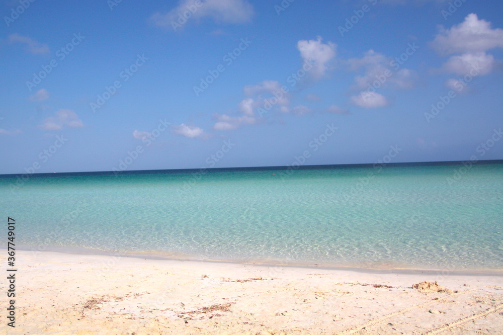 Beautiful paradise panorama of a white sand beach and turquoise blue green water sea in Cuba.