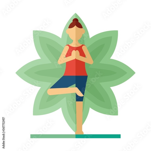 woman practicing yoga in tree pose