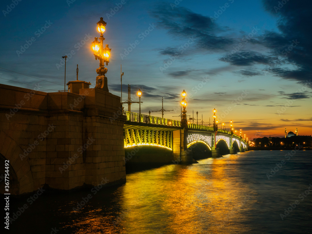 Drawnbridge with night lighting over the river in the city Drawnbridge with night lighting over the river in the city