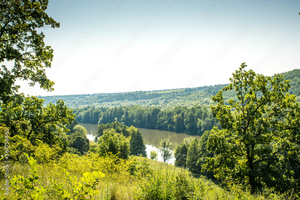 Beautiful summer landscape of green nature. Forest, river and hills