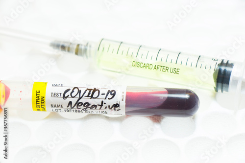 Medical needle and blood tube, corona virus or covid-19 vaccine.