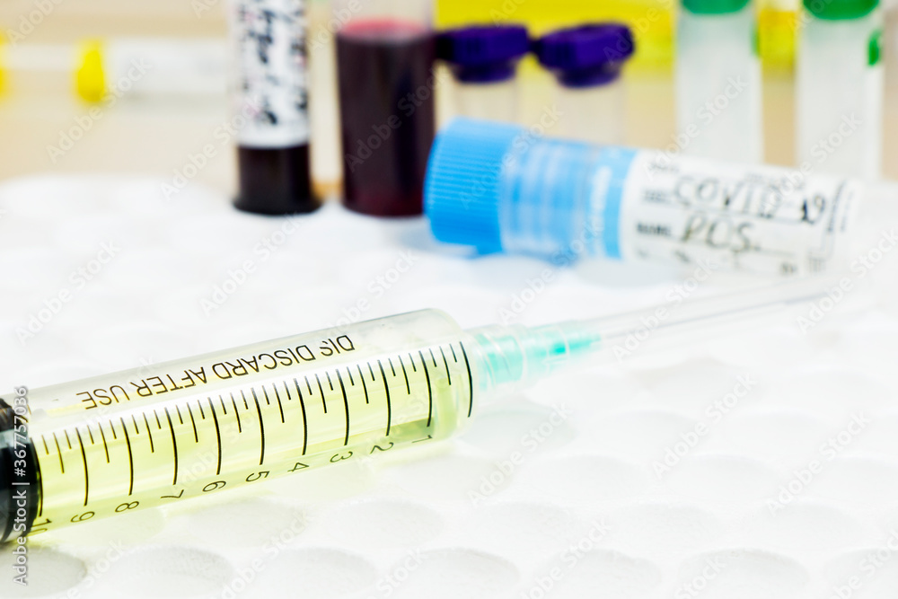 Medical needle and blood tube, corona virus or covid-19 vaccine.