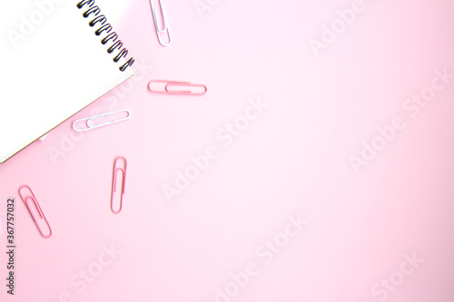 School stationery and supplies on a pink background with space for caption. Back to school, homeschool creative workspace. Minimalistic set of colorful stationery. Flat lay