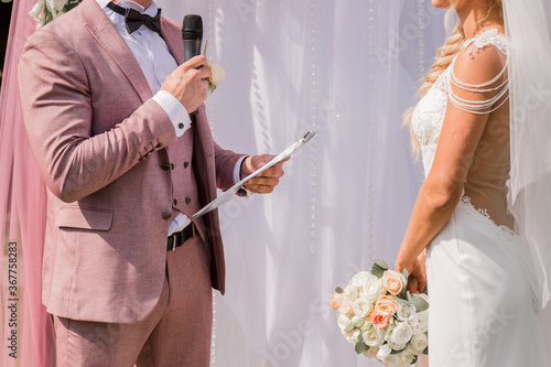 groom with microphone at wedding ceremony
