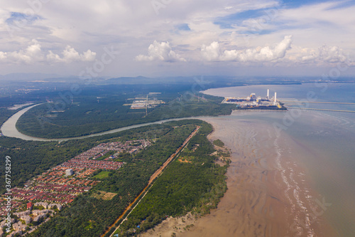 An aerial view of the dock of a Coal Power Plant at the Malaysia west coast. Two coal cargo ship at the dock to supply coal to the plant. At the polluted west coast of strait of Malacca. 