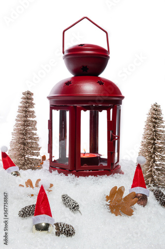 Wallpaper Mural Red Christmas lantern on snow with pine cones, small cones, leaves, golden christmas trees, small golden baubles with santa hats in front of a white background, copy space Torontodigital.ca