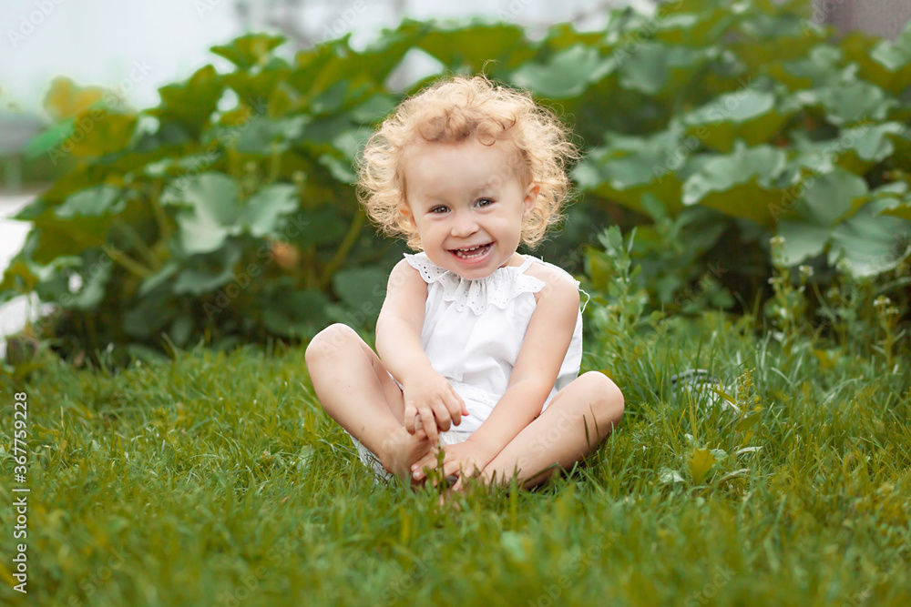 Adorable laughing little girl with long blond curly hair Adorable laughing little girl with long blond curly hair