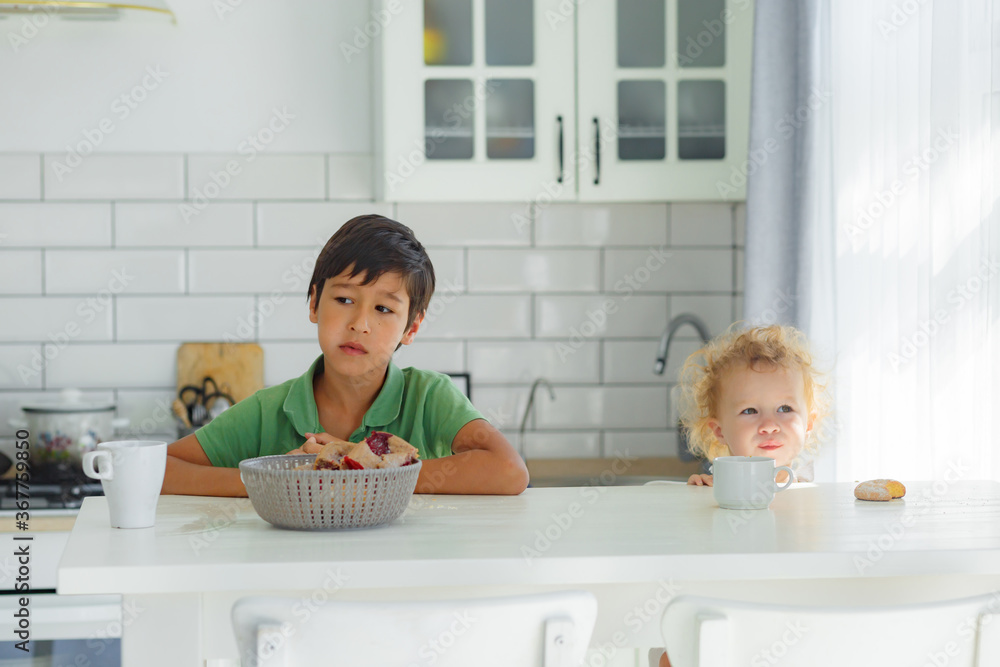 A brother and a sister having their breakfast A brother and a sister having their breakfast