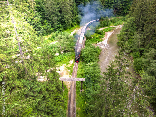 Steam train Mocanita Maramures from Romania near wooden gate photo