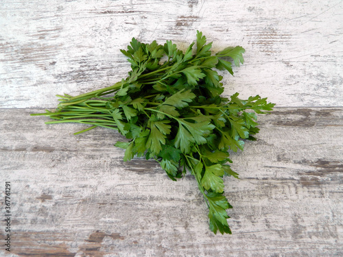 parsley isolated on wooden background