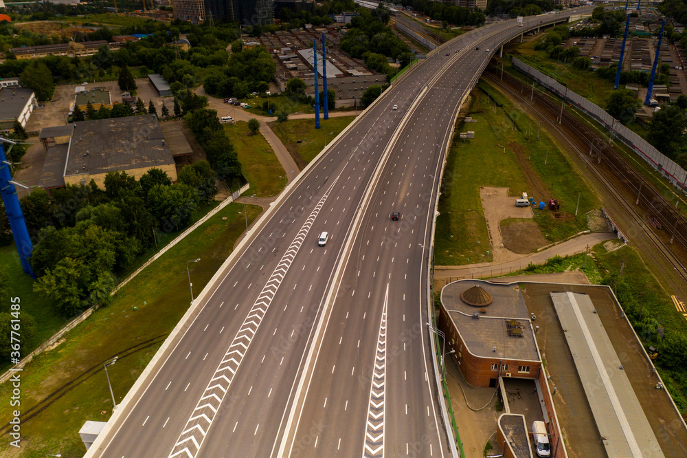 panoramic view of the morning city with roads, cars and junctions panoramic view of the morning city with roads, cars and junctions