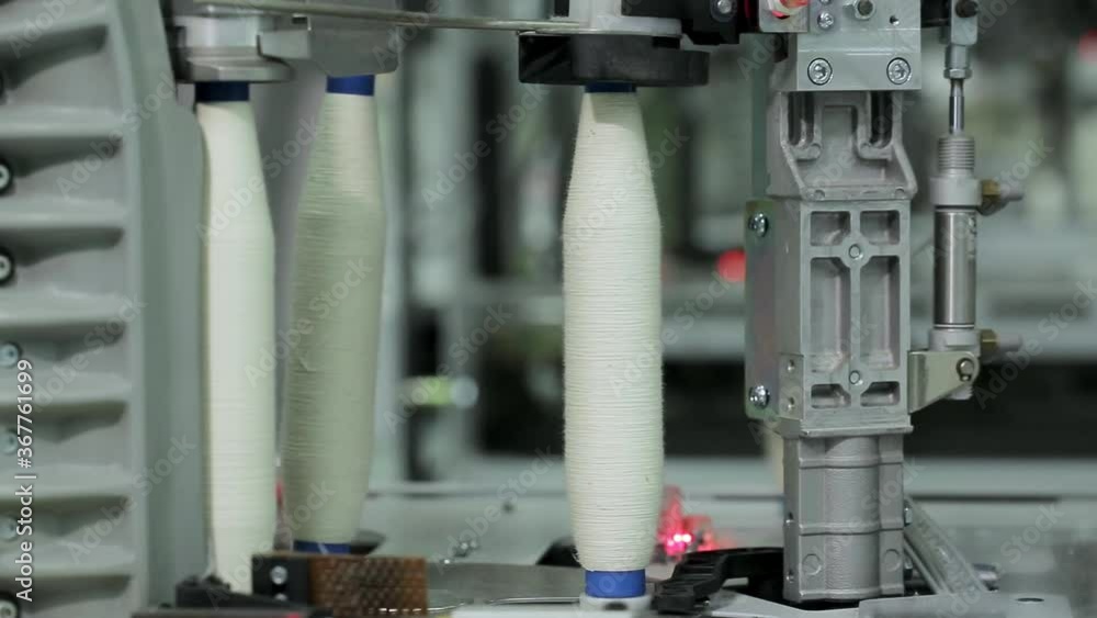 Close-up of bobbins with cotton threads moving along the conveyor .Textile industry, yarn production . Close-up of bobbins with cotton threads moving along the conveyor .Textile industry, yarn production .