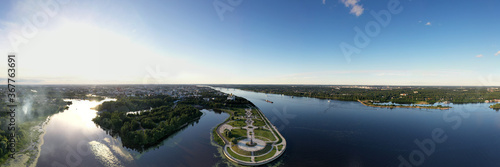 an amusement and recreation park with fountains on a peninsula next to a large river filmed from a drone © константин константи