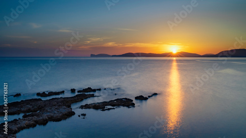 View over the sea at sunset in Alghero, italy