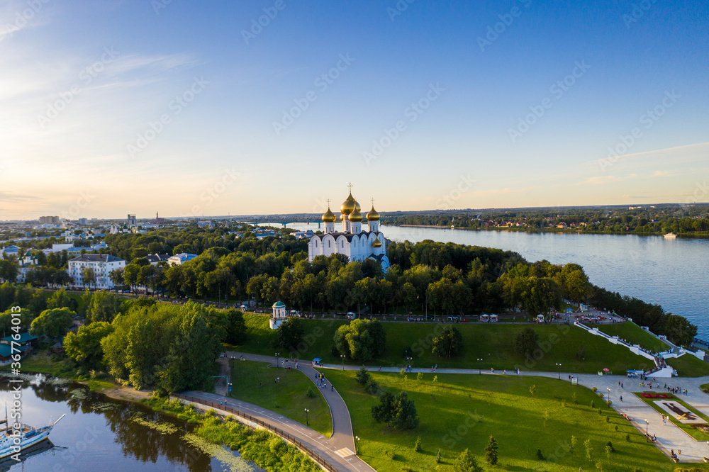 a large city with churches from the embankment along the river filmed from a drone