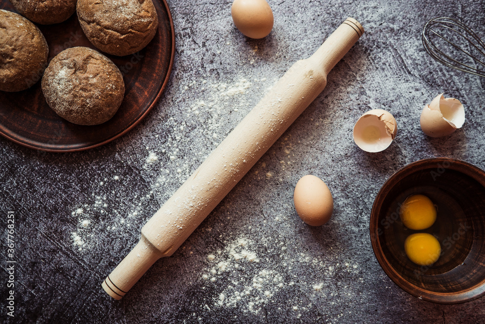 ingredients for baking rye buns, rolling pin, eggs, flour, mixer on gray background 2 ingredients for baking rye buns, rolling pin, eggs, flour, mixer on gray background 2